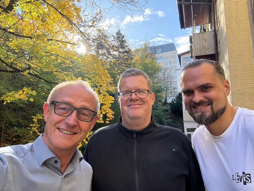 3 personen lachen in die Kamera