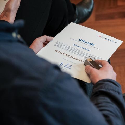 Urkunde und Ehrennadel in Nahaufnahme